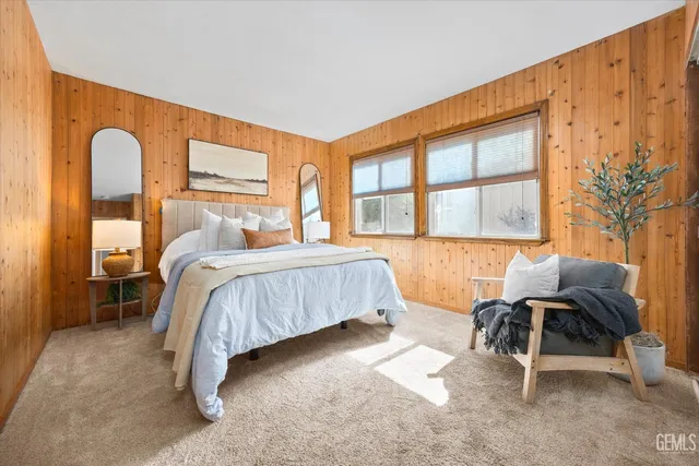 a bedroom with a bed and a large window