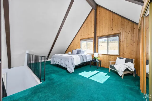 a bed room with a bed and a chair