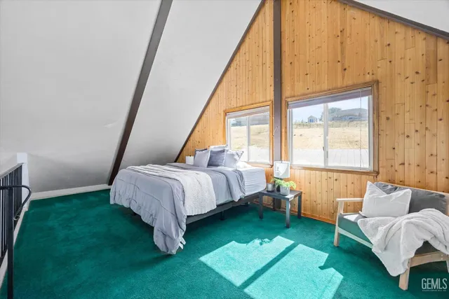 a bedroom with furniture and a rug