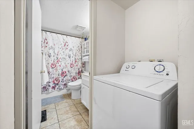 a view of a yard with wooden fence