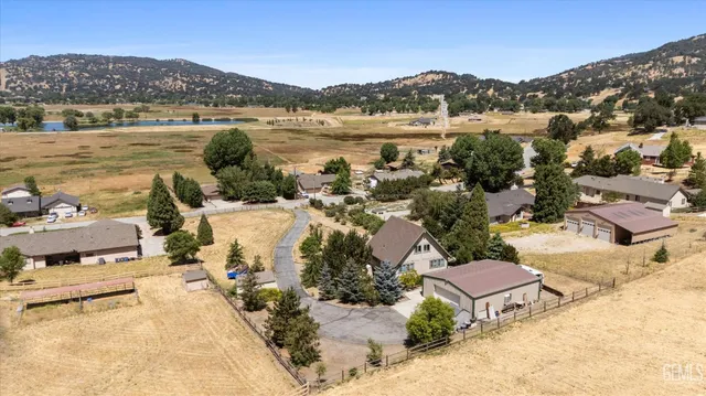 a living room with furniture a flat screen tv and a large window