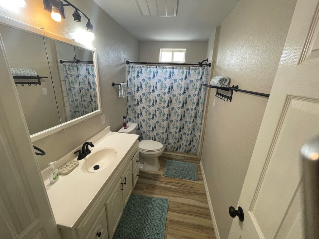1016 Hardee Street Rockport, TX 78382 - Photo 12 of 14 a bathroom with a double vanity sink toilet and shower