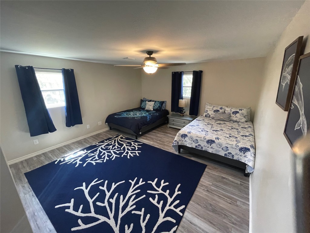 1016 Hardee Street Rockport, TX 78382 - Photo 13 of 14 a bedroom with a bed and a chandelier