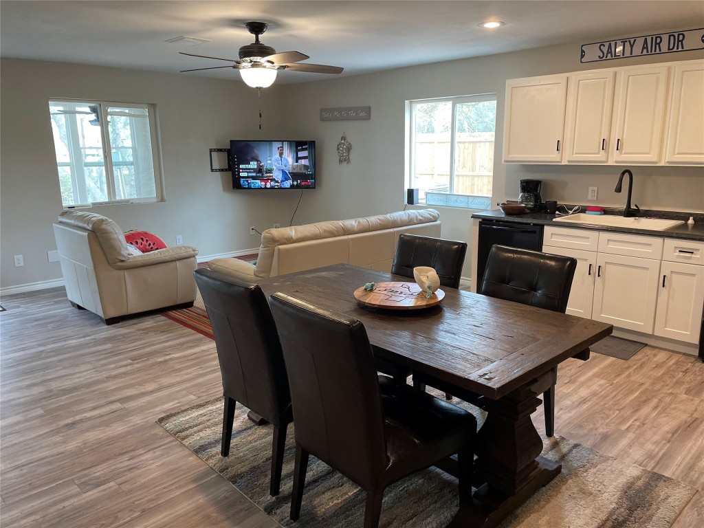 1016 Hardee Street Rockport, TX 78382 - Photo 5 of 14 a view of a dining room with furniture and wooden floor