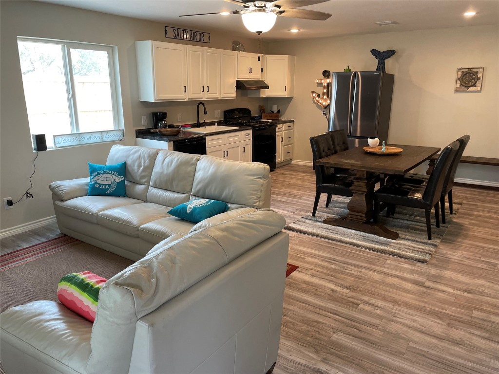 1016 Hardee Street Rockport, TX 78382 - Photo 6 of 14 a living room with furniture and a wooden floor