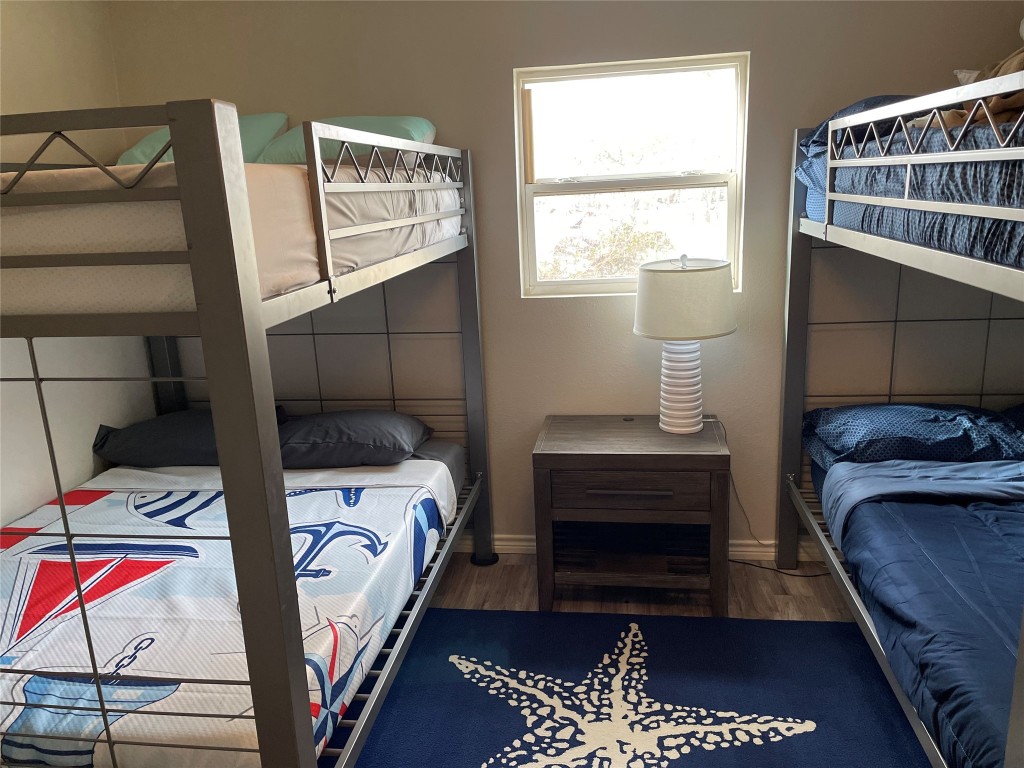 1016 Hardee Street Rockport, TX 78382 - Photo 7 of 14 a bedroom with a bed and wooden floor