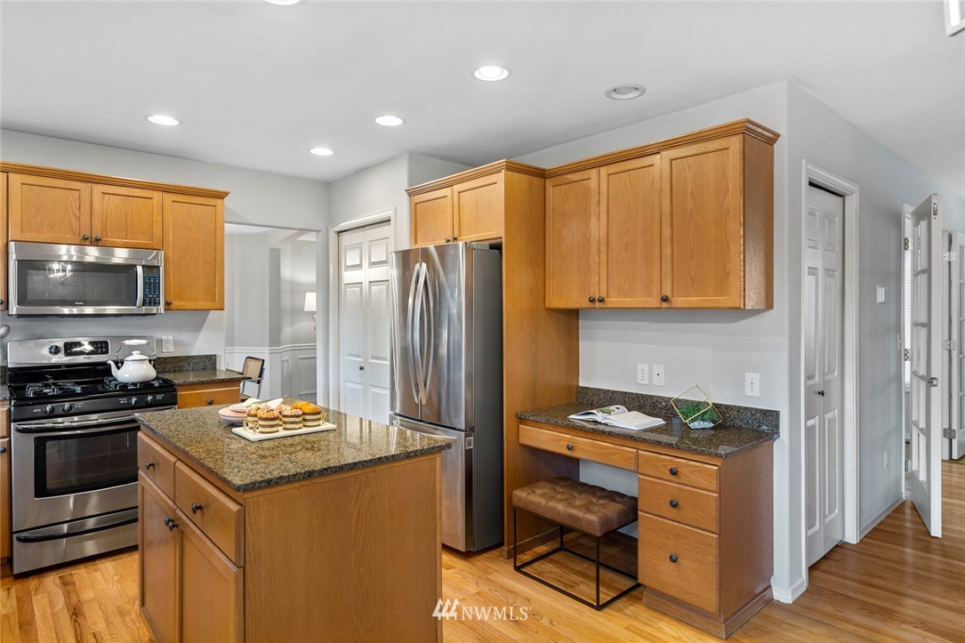 5112 Northeast 20th Street Renton, WA 98059 - Photo 13 of 40 a kitchen with a refrigerator stove and sink