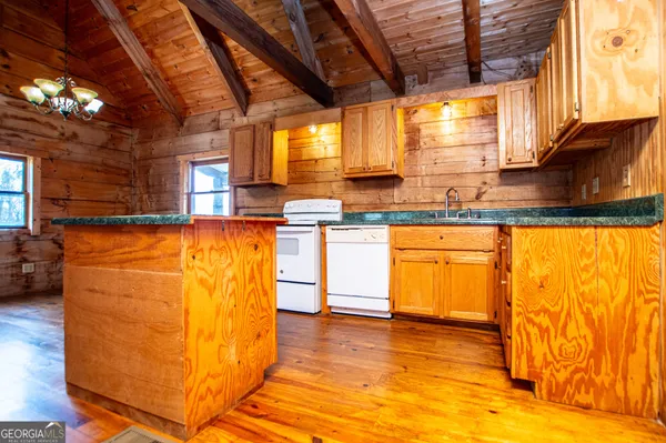 en empty room with wooden floor and windows