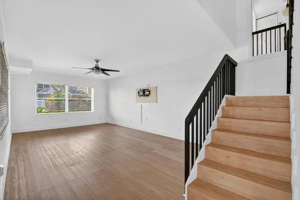 a view of an entryway with wooden floor and stairs