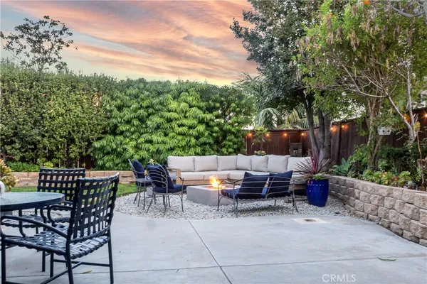 a view of backyard with seating area and green space