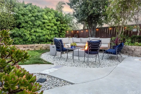 a view of backyard with seating area and green space