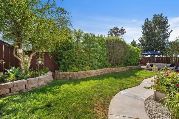 a view of a backyard with sitting area