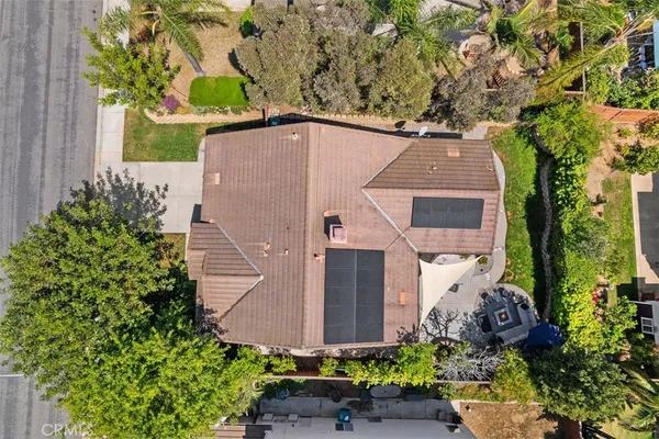 an aerial view of a house with a yard and garden
