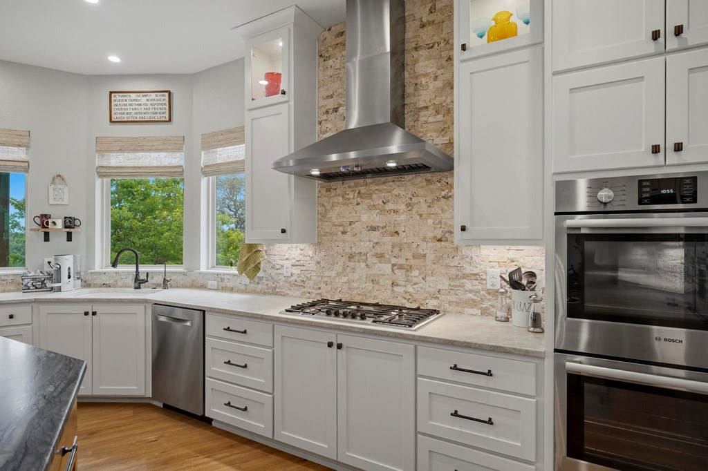 134 North Stallion Ests Drive Spring Branch, TX 78070 - Photo 19 of 67 a kitchen with stainless steel appliances white cabinets and a stove