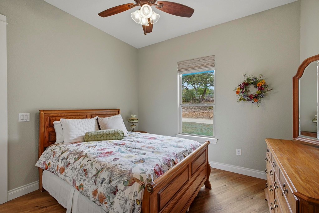 134 North Stallion Ests Drive Spring Branch, TX 78070 - Photo 27 of 67 a bed sitting in a bedroom next to a window
