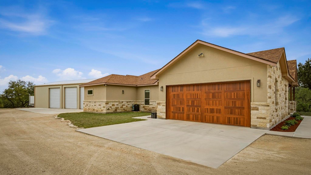 134 North Stallion Ests Drive Spring Branch, TX 78070 - Photo 39 of 67 a front view of a house with a yard and garage