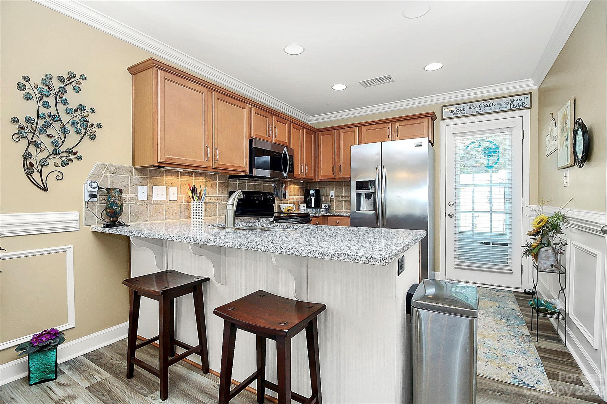 1919 Sandal Brook Road Indian Land, SC 29707 - Photo 11 of 35 a kitchen with stainless steel appliances granite countertop a refrigerator and a stove top oven