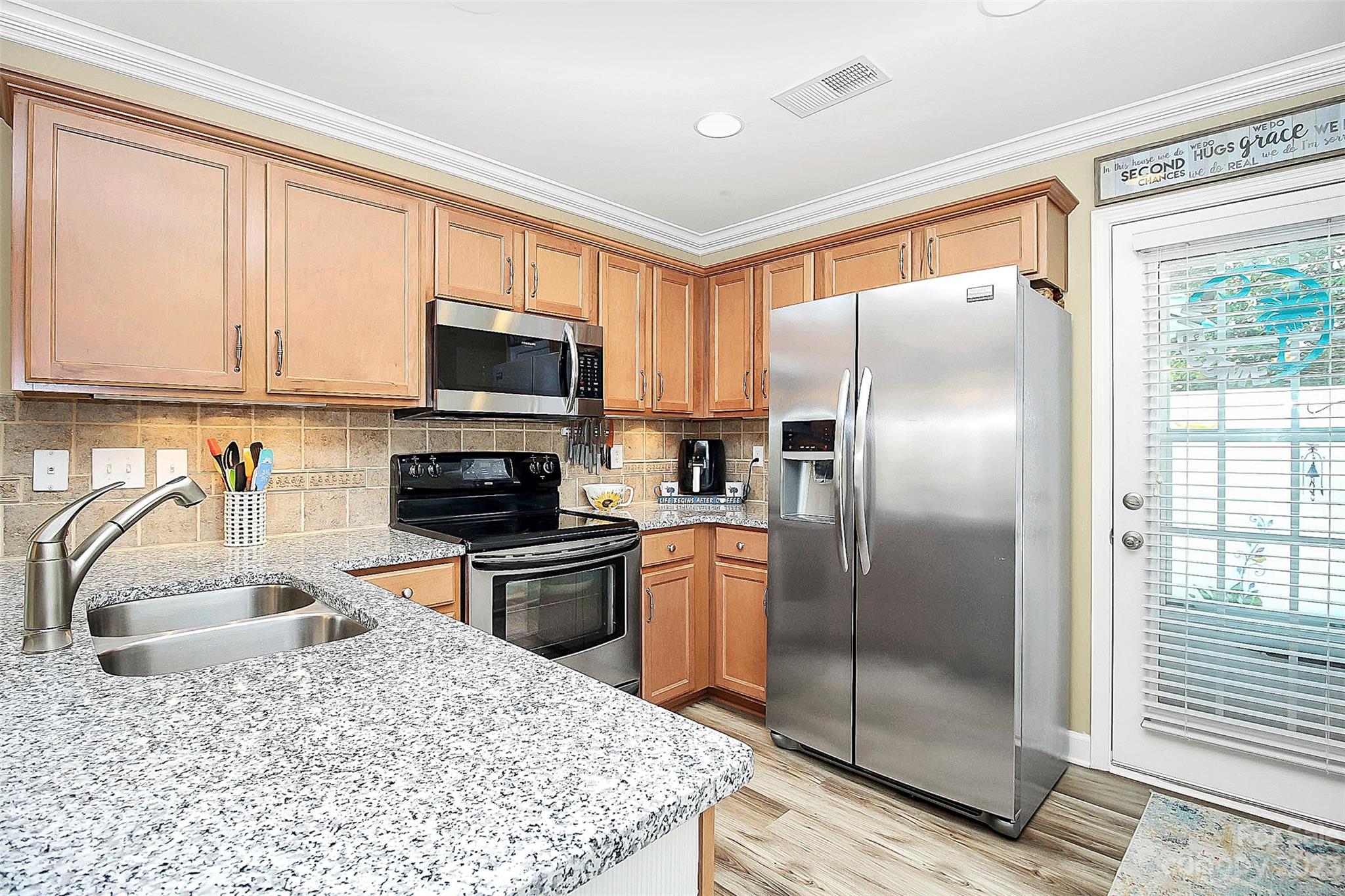 1919 Sandal Brook Road Indian Land, SC 29707 - Photo 12 of 35 a kitchen with granite countertop a refrigerator oven a sink and a window