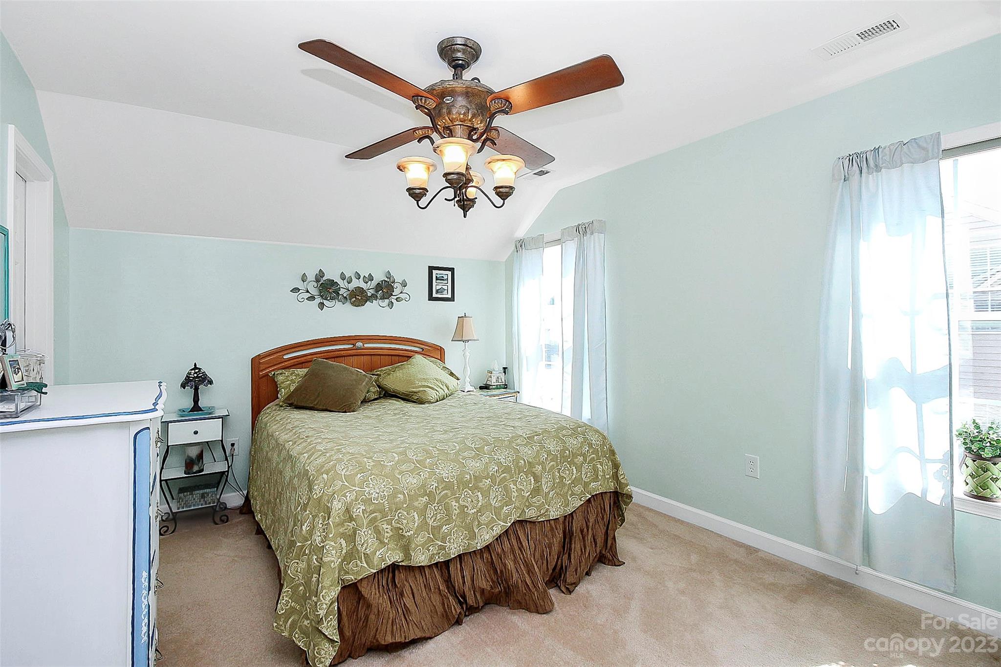 1919 Sandal Brook Road Indian Land, SC 29707 - Photo 24 of 35 a bedroom with a bed and a chandelier