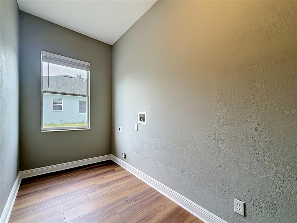 28549 Shirley Shores Road Tavares, FL 32778 - Photo 51 of 65 a view of an empty room with wooden floor and a window