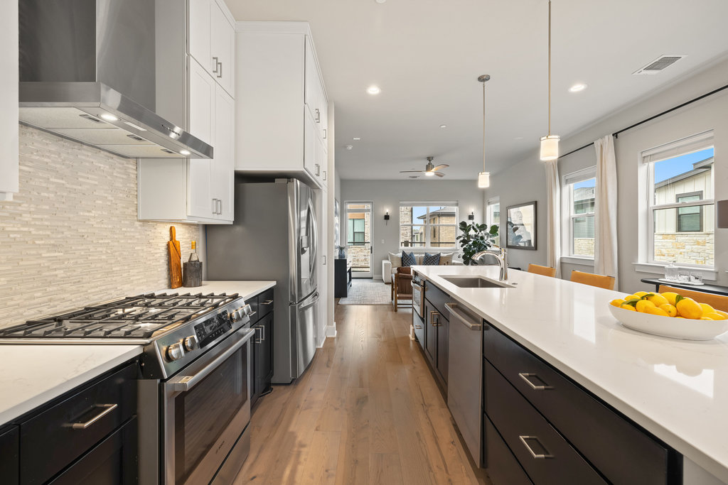 3900 Sightline Street, Unit 127 Austin, TX 78731 - Photo 19 of 39 a kitchen with stainless steel appliances granite countertop a sink stove and refrigerator
