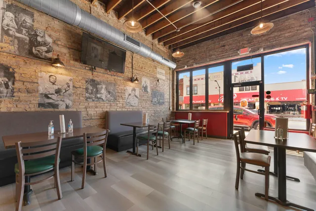 a dining room with furniture floor to ceiling windows and plants