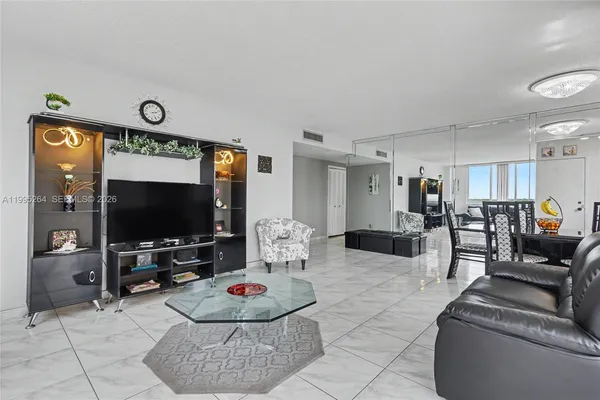 a living room with lots of furniture a rug a fireplace and a counter top space