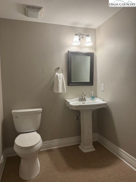 567 Locust Road Newland, NC 28657 - Photo 18 of 28 a bathroom with a toilet sink and mirror
