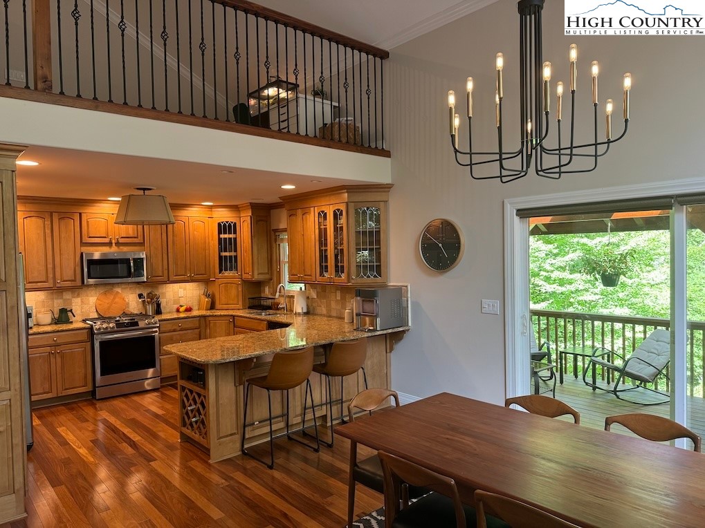 567 Locust Road Newland, NC 28657 - Photo 6 of 28 a view of a dining room with furniture window and wooden floor