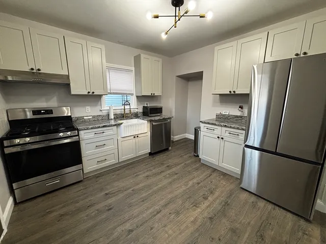 a kitchen with stainless steel appliances a refrigerator stove and sink