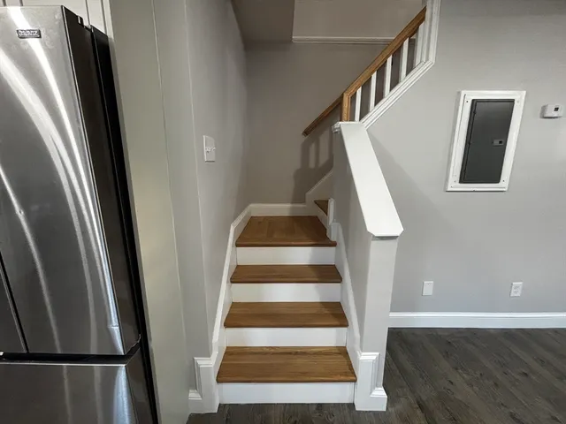 a view of entryway with wooden floor and stairs