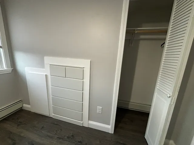 an empty room with wooden floor and closet