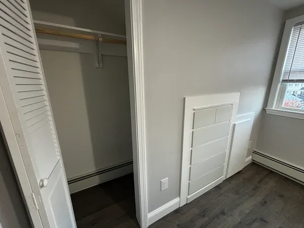 a view of walk in closet with wooden floor