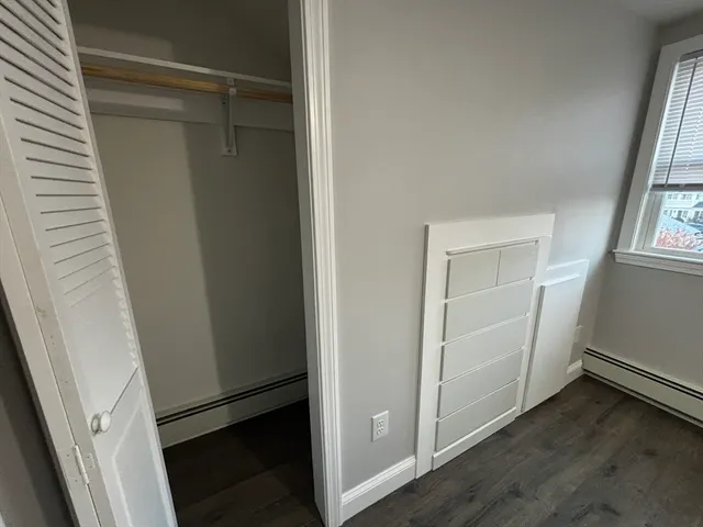 a view of walk in closet with wooden floor