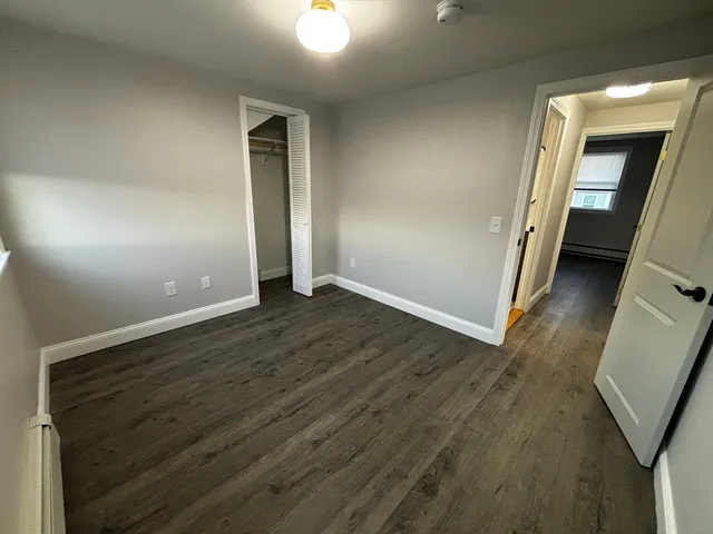 wooden floor in an empty room with a mirror