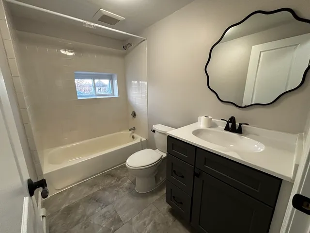 a bathroom with a sink a toilet and a mirror