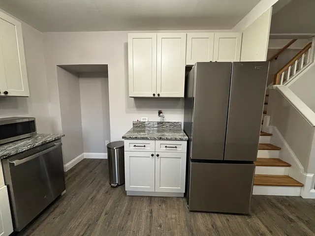 a kitchen with a refrigerator sink and stove