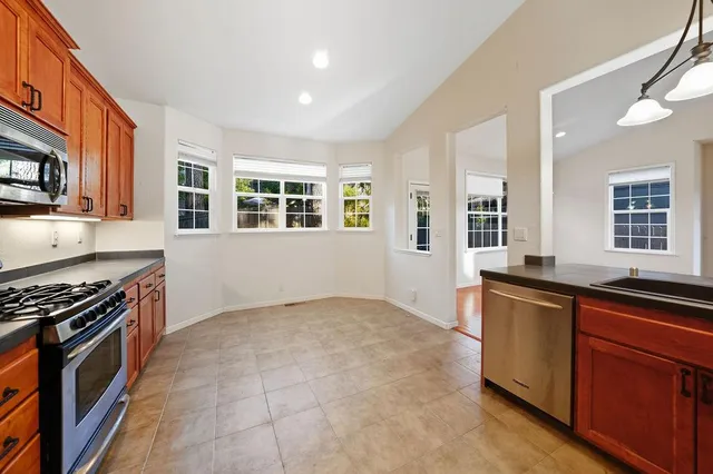 a kitchen with granite countertop a stove and cabinets