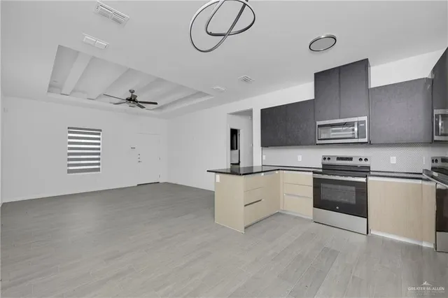 a kitchen with granite countertop a stove and a sink