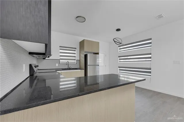 a view with a counter top space in kitchen and a window