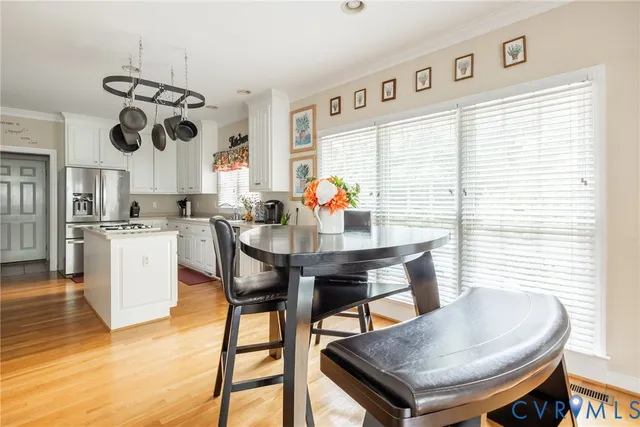 a view of a dining room with furniture and window
