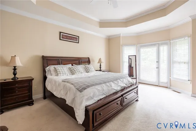 a spacious bedroom with a bed and a cabinets