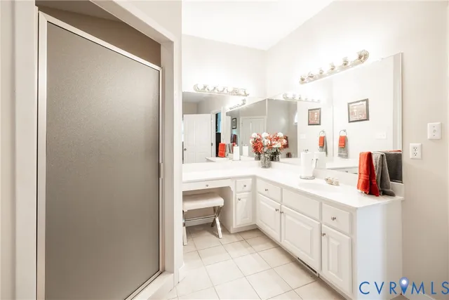 a spacious bathroom with a sink and a mirror
