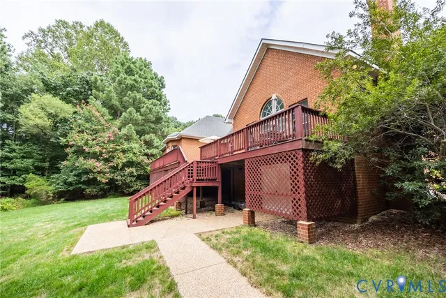 a view of a house with a yard and stairs