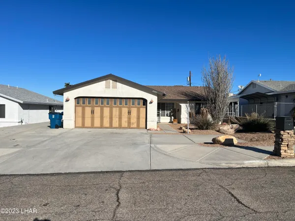 a view of a house with outdoor space and parking