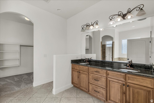 691 Rainier Drive St. George, UT 84770 - Photo 6 of 24 Bathroom featuring a spacious closet, double vanity, light tile patterned flooring, and recessed lighting