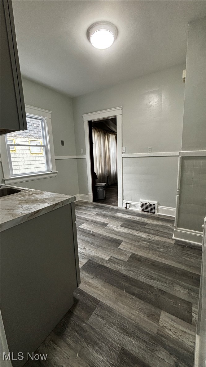 13421 Ashburton Road Cleveland, OH 44110 - Photo 7 of 28 Kitchen with gray cabinets and dark hardwood / wood-style flooring