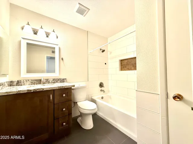 a bathroom with a bathtub sink mirror and toilet