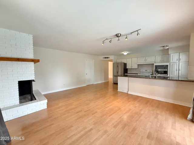 a view of kitchen with kitchen island microwave and stove