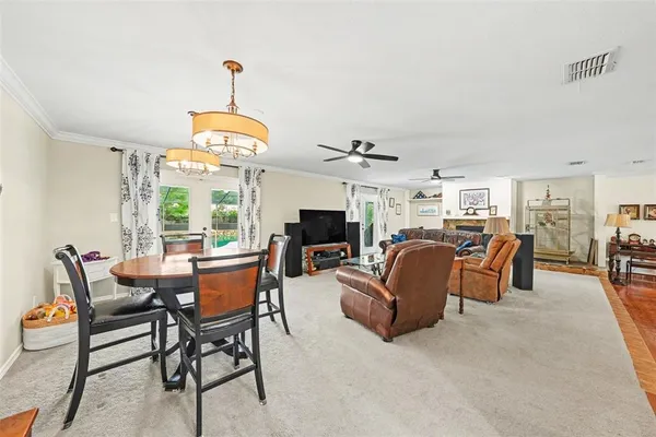 a dining room with furniture a livingroom and chandelier